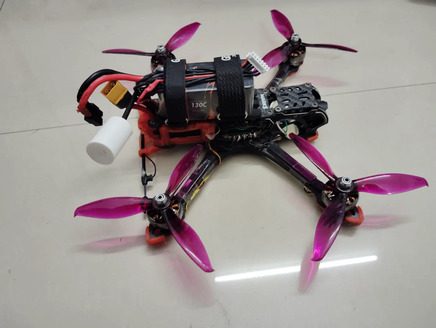 Custom-built FPV racing drone with illuminated frame